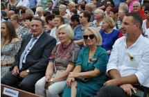 Uczetsnicy dożynek siedzą na ławakch