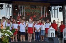 Kilkunastu dzieci na scenie podczas występu artystycznego 