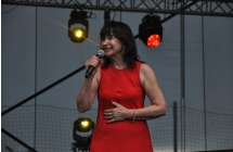 Elegancko ubrana kobieta stojąca na scenie 
