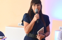 Elegancko ubrana kobieta mówiąca do mikrofonu 