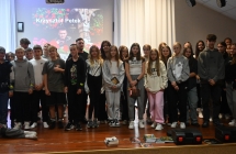 Zdjęcie grupowe osób biorących udział w wydarzeniu, Stoją na scenie. 