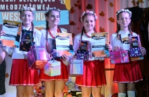 Cztery dziewczynki w jednakowych strojach na scenie