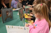 Dzieci oglądające książki o dinozaurach 