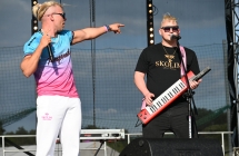 Dwoje mężczyzn na scenie. Jeden gra na gitarze, drugi śpiewa do mikrofonu