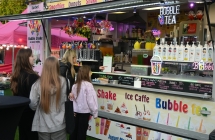 Trzy dziewczynki przy stoisku gastronomicznym 