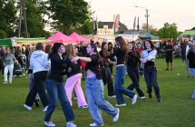 Kilkadziesiąt osób tańczących na placu imprezy masowej 